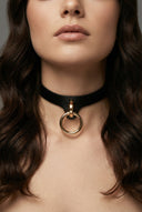woman wearing black leather collar with gold ring