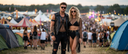 men and woman at a summerfestival in their  festival outfit