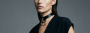 sophisticated women wearing a black with gold leather collar