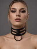 A close-up portrait of a woman wearing a black leather bdsm collar with a large circular ring at the front, set against a solid gray studio background