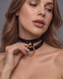 Woman touching gold O-ring on AKASHA leather BDSM collar